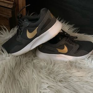 Gray and gold Nike sneakers